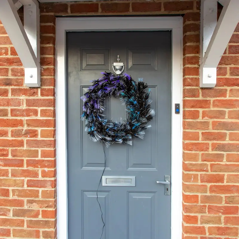 60Cm Elegant Black Christmas Wreath Accented With Blue Fibre Optic Lights 1